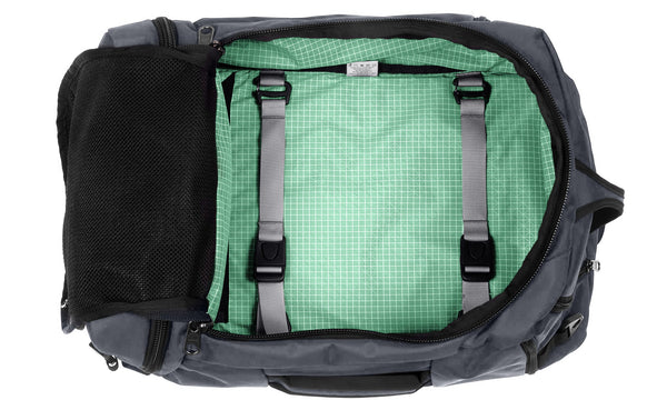 An open Techonaut 30 with a Nebulous Grey (dark grey) exterior and an Seafoam (pale green) interior.